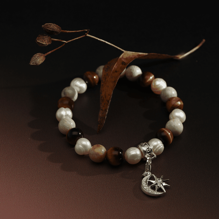 Thomas Sabo Jáspis gyöngy és tigrisszem gumis karkötő Thomas Sabo Jáspis gyöngy és tigrisszem gumis karkötő charm tartóval