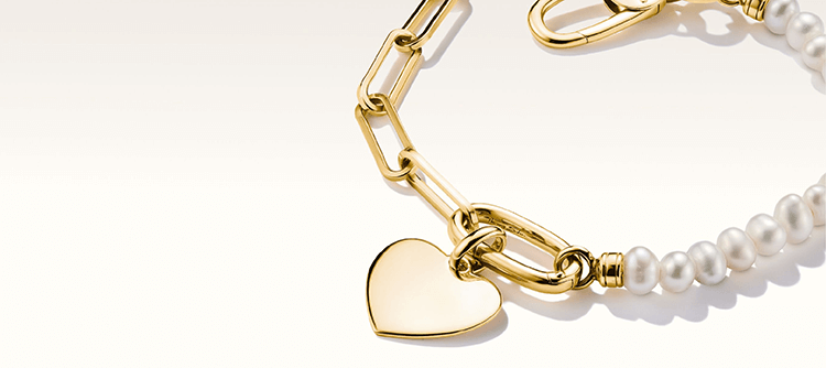 Thomas Sabo Gyöngy és hosszúkás szemű aranyozott ezüst karkötő connect charmmal